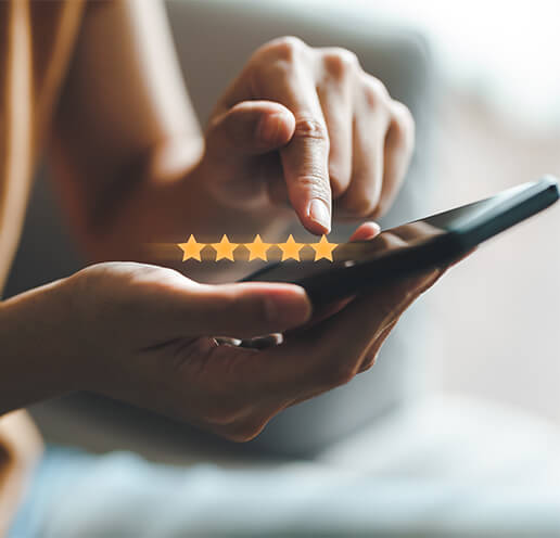 a person holding a phone with five stars